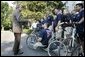 President George W. Bush speaks with members of Soldier Ride 2005 National Tour Team on the South Lawn of the White House, Sunday, July 10, 2005. Soldier Ride 2005, comprised of wounded service members, is a 4,200-mile, cross-country bike ride to raise money and support to help prepare wounded soldiers for long-term rehabilitation.  White House photo by Eric Draper