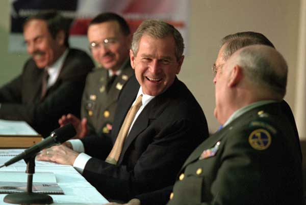 President George W. Bush shares a laugh with, from left, West Virginia Governor Robert Wise, Colonel Bill Raney, President of the Army National Guard, Secretary of Defense Donald Rumsfeld, and Lieutenant Colonel Chester Carter of the Army National Guard during a visit to the West Virginia National Guard Headquarters in Charleston, West Virginia on February 14, 2001