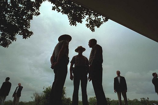 President George W. Bush talks with national park service officers at the Royal Palm Visitors Center at Everglades National Park, Fla., June 4, 2001. White House photo by Eric Draper.