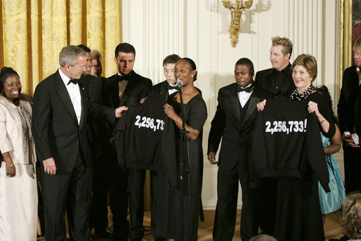 President George W. Bush and Mrs. Laura Bush hold jackets they were given by Special Olympics athletes after they listened to the band Rascal Flatts in the East Room of the White House following a dinner honoring the Special Olympics and founder Eunice Kennedy Shriver, Monday, July 10, 2006. White House photo by Paul Morse