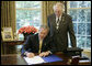 President George W. Bush is joined by U.S. Rep. Roscoe Bartlett, R- Md., as he signs H.R. 42, Freedom to Display the American Flag Act of 2005, Monday, July 24, 2006, in the Oval Office of the White House. The bill prevents a condominium association, cooperative association, or residential real estate management association from denying an owner or resident from displaying the U.S. flag on their residential property within the association. White House photo by Paul Morse