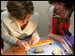 Mrs. Laura Bush receives instruction in arts and crafts Monday, July 17, 2006, during an exhibit at the Baltic Star Hotel on the grounds of the Konstantinovsky Palace Complex in Strelna, Russia, site of the G8 Summit that ended Monday. White House photo by Shealah Craighead