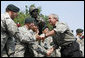 President George W. Bush meets U.S. Airborne and Special Forces troops following his remarks Tuesday, July 4, 2006, during an Independence Day celebration at Fort Bragg in North Carolina. President Bush thanked the troops and their families for their service to the nation. White House photo by Paul Morse