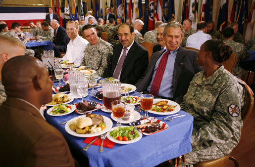 President George W. Bush and Iraqi Prime Minister Nouri al-Maliki share some conversation and lunch with military personnel Wednesday, July 26, 2006, at Fort Belvoir, Va. White House photo by Paul Morse