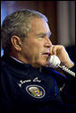 President George W. Bush calls world leaders concerning the situation in the Middle East from his Air Force One office en route to the G8 Summit in St. Petersburg, Russia, Friday, July 14, 2006. White House photo by Eric Draper