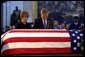 President George W. Bush and Laura Bush pay their final respects at the casket containing the body of former President Ronald Reagan in the U.S. Capitol Rotunda, Thursday, June 10, 2004. White House photo by Eric Draper.