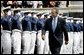 President George W. Bush walks to the stage while saluted by Air Force Cadets during his introduction at the United States Air Force Academy Graduation Ceremony in Colorado Springs, Colorado, June 2, 2004. White House photo by Eric Draper.