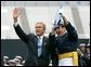 President George W. Bush celebrates with a graduating Air Force Cadet during the United States Air Force Academy Graduation Ceremony in Colorado Springs, Colorado, June 2, 2004. White House photo by Eric Draper.