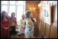 Mrs. Laura Bush looks over a photographic exhibit during a luncheon in Mar del Plata Saturday, Nov. 5, 2005, hosted by Argentine First Lady Mrs. Cristina Fernandez de Kirchner, far left. White House photo by Krisanne Johnson