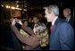 President George W. Bush poses for a photo with an audience member after delivering remarks in Brasilia, Brazil, Sunday, Nov. 6, 2005. White House photo by Eric Draper