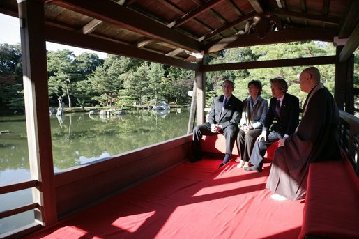 President George W. Bush, Mrs. Bush, Japan’s Prime Minister Junichiro Koizumi and the Reverend Raitei Arima, Chief Priest of the Golden Pavilion Kinkakuji Temple, pause during a cultural visit to the temple Wednesday, Nov. 16, 2005, in Kyoto. White House photo by Eric Draper