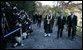 President George W. Bush and Japan’s Prime Minister Junichiro Koizumi join the Reverend Raitei Arima, Chief Priest of the Golden Pavilion Kinkakuji Temple in Kyoto, as they walk past the press during a cultural visit to the temple Wednesday, Nov. 16, 2005. White House photo by Eric Draper