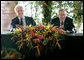 President George W. Bush enjoys a light moment with U.S. Ambassador to Brazil John Danilovich during a roundtable discussion with young leaders from Brazil, Sunday, Nov. 6, 2005 in Brasilia, Brazil. White House photo by Eric Draper