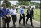 President George W. Bush enjoys a walk with Brazilian President Luiz Inacio Lula da Sliva following their joint statement at the Granja do Torto in Brasila, Brazil, Sunday, Nov. 6, 2005. White House photo by Paul Morse