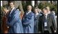 President George W. Bush peaks out behind Mexico President Vincente Fox, left, with Japan's Prime Minister Junichiro Koizumi as APEC leaders walk to the official photograph site Saturday, Nov. 19, 2005, at the Nurimaru APEC House in Busan, Korea. White House photo by Eric Draper