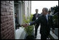 President George W. Bush reaches out for the hand of a well-wisher after participating in the 2005 class photo during opening ceremonies Friday, Nov. 4, 2005, of the Summit of the Americas in Mar del Plata, Argentina. White House photo by Eric Draper