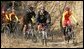 President George W. Bush leads the pack as he joins China's Mountain Biking Team for a ride Sunday afternoon, Nov. 20, 2005, in Beijing. White House photo by Paul Morse