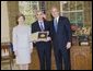 President George W. Bush and Laura Bush stand with Dereck Gillman, President of the Pennsylvania Academy of Fine Arts, who on the academy's behalf, was presented the 2005 National Medal of Arts, in the Oval Office Thursday, Nov. 10, 2005. White House photo by Eric Draper