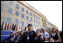 Sitting in front of the rebuilt section of the Pentagon, service personnel and families listen to President George W. Bush at the Pentagon Observance Wednesday, Sept. 11. "One year ago, men and women and children were killed here because they were Americans. And because this place is a symbol to the world of our country's might and resolve," said the President. "Today, we remember each life. We rededicate this proud symbol and we renew our commitment to win the war that began here."