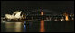 A welcoming APEC 2007 marquis adorns Sydney’s Harbour Bridge at sunset Thursday, Sept. 6, 2007. At left is the Sydney Opera House. White House photo by Chris Greenberg