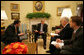 President George W. Bush goes over a draft of tonight's address to the nation with members of the White House speechwriting staff Thursday, Sept. 13, 2007, in the Oval Office. With him, from left, are: Marc Thiessen, Bill McGurn and Christopher Michel. White House photo by Eric Draper