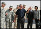 President George W. Bush waves after arriving at Al Asad Airbase, Al Anbar Province, Iraq, Monday, September 3, 2007. The greeting party from left are Lieutenant General Raymond Odierno, Commanding General, Multi-National Corps, General David Petraeus, Commander, Multi-National Force Iraq, Admiral William Fallon, Commander US Central Command, General Peter Pace, Chairman of the Joint Chiefs of Staff, Secretary of Defense Robert Gates and Secretary State Condoleezza Rice. White House photo by Eric Draper