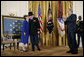 President George W, Bush applauds as Medal of Honor recipient U.S. Army Major Bruce P. Crandall kisses his wife, Arlene, in the East Room of the White House, Monday, Feb. 26, 2007. Crandall was awarded the Medal of Honor for his extraordinary heroism as a 1st Cavalry helicopter flight commander in the Republic of Vietnam in November 1965. White House photo by Eric Draper