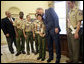 President George W. Bush hugs Cub Scout Bryson Hicks, 10, of San Diego, Calif., as he is given a statue of a Cub Scout in the Oval Office Monday, Feb. 26, 2007. In 2005 Bryson rescued his 4-year-old cousin, who waded into a lake after a remote control boat. Byrson used skills he learned in Scouting to save save his cousin. The scouts presented the President with the Boy Scouts of America's Report to the Nation, highlighting the organization's accomplishments during the past year. White House photo by Eric Draper