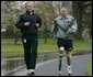 President George W. Bush runs with U.S. Army Staff Sergeant Michael McNaughton, of Denham Springs, La., on the South Lawn April 14, 2004. The two met Jan. 17, 2003, at Walter Reed Army Medical Center, where SSgt. McNaughton was recovering from wounds sustained in Afghanistan. The President wished SSgt. McNaughton a speedy recovery so that they might run together in the future. White House photo by Eric Draper.