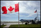 Air Force One, framed between the flags of the United States and Canada, is seen Tuesday, Aug. 21, 2007 on the tarmac in Ottawa, Canada, awaiting the arrival of President George W. Bush after the conclusion of the North American Leader’s Summit in Montebello, Quebec. President Bush flew on to Minneapolis for an update meeting on the I-35W bridge collapse and Minnesota flooding. White House photo by Eric Draper