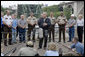 President George W. Bush talks to members of the media following his aerial and ground survey of the Interstate 35W bridge collapse in Minneapolis, Saturday, Aug. 4, 2007, where President Bush praised the work of first responders, local authorities and investigators in their response and work at the collapse scene. President Bush said he would work to help local, state and federal authorities to cut through the red tape to get the bridge rebuilt as soon as possible. White House photo by Chris Greenberg