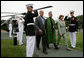 President George W. Bush and Mrs. Laura Bush walk with President Hamid Karzai of Afghanistan during an arrival ceremony at Camp David, Sunday, August 5, 2007. White House photo by Eric Draper