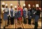 Mrs. Laura Bush and students at Cardozo Senior High School pose for pictures Monday, Dec. 19, 2005, in Washington, D.C. Mrs. Bush was on hand to join the Youth Services Opportunities Project in assembling sandwiches for Martha's Table's mobile soup kitchen. White House photo by Shealah Craighead