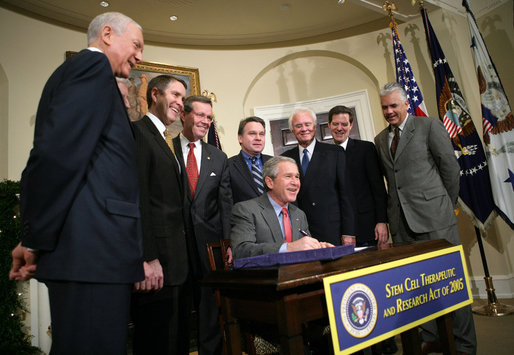 President George W. Bush smiles as he signs into law H.R. 2520, the Stem Cell Therapeutic and Research Act of 2005, during ceremonies Tuesday, Dec. 20, 2005, in the Roosevelt Room of the White House. White House photo by Paul Morse