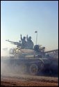 Vice President Dick Cheney visits the 9th Mechanized Infantry Division Headquarters at Taji Air Base to greet Iraqi troops and view tanks and armored vehicles they have refurbished into working fighting vehicles, Sunday Dec. 18, 2005. White House photo by David Bohrer