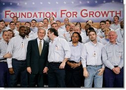 President George W. Bush greets workers following his remarks on the economy and tax relief in Kernersville, N.C., where he toured the John Deere-Hitachi excavator assembly line, Monday, Dec. 5, 2005.  White House photo by Eric Draper