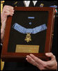 A White House military aide holds the Medal of Honor presented posthumously to U.S. Army Master Sgt. Woodrow Wilson Keeble by President George W. Bush, Monday, March 3, 2008 in the East Room of the White House. Master Sgt. Keeble, the first full-blooded Sioux Indian to receive the Medal of Honor, was recognized for his gallantry above and beyond the call of duty during military action in the Korean War. White House photo by Eric Draper