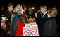 President George W. Bush acknowledges the taste of bread -- presented as a traditional Ukrainian welcome -- as he and Mrs. Laura Bush are greeted upon their arrival Monday, March 31, 2008, at Boryspil State International Airport in Kyiv. White House photo by Eric Draper