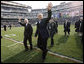 President George W. Bush walks onto the playing turf at Philadelphia's Lincoln Financial Field with U.S. Secretary of Defense Robert Gates Saturday, Dec. 6, 2008, for the 2008 Army-Navy game. The rivalry, a tradition since 1908, was won by the Midshipmen, who delivered a 28-0 shutout to the Black Knights. White House photo by Eric Draper