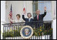 President George W. Bush, Laura Bush and Prime Minister Junichiro Koizumi of Japan wave from the South Portico Balcony at the conclusion of the official arrival ceremony Thursday, June 29, 2006. White House photo by Eric Draper