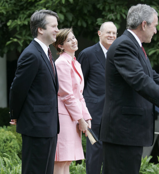 Brett and Ashley Kavanaugh and Justice Anthony Kennedy react to President George W. Bush during the Rose Garden swearing-in ceremony Thursday, June 1, 2006, for Mr. Kavanaugh to the U.S. Court of Appeals for the District of Columbia. White House photo by Eric Draper
