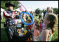 Children attending the annual Congressional Picnic on the South Lawn of the White House Wednesday evening, June 15, 2006, are enthralled as they watch a cowboy balloon artist. White House photo by Kimberlee Hewitt