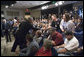 Audience and family members greet President George W. Bush during the signing of S. 2803, The MINER Act, in the Dwight D. Eisenhower Executive Office Building Thursday, June 15, 2006. White House photo by Eric Draper