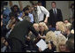 President George W. Bush greets family members of miner Marty Bennett during the signing of S. 2803, The MINER Act, in the Dwight D. Eisenhower Executive Office Building Thursday, June 15, 2006. Mr. Bennett died in the Sago Mine disaster in West Virginia. White House photo by Eric Draper