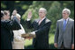 President George W. Bush stands with former Idaho Gov. Dirk Kempthorne as he is sworn-in as the new U.S. Secretary of Interior by Supreme Court Justice Antonin Scalia, left, Wednesday, June 7, 2006 on the South Lawn of the White House in Washington. Patricia Kempthorne holds the Bible during her husband’s swearing-in, joined by their children Heather Myklegard and son, Jeff Kempthorne. White House photo by Eric Draper