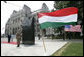 President George W. Bush and Mrs. Laura Bush stand in silence after laying flowers at the eternal flame of the 1956 Memorial Monument outside the Hungarian Parliament in Budapest, Hungary, Thursday, June 22, 2006. The monument honors victims of the failed 1956 Hungarian uprising against Soviet rule. White House photo by Eric Draper