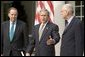 Accompanied by Chairman Thomas Kean, left, and Vice Chairman Lee Hamilton of the 911 Commission, President George W. Bush addresses the press during the presentation of the Commission's report in the Rose Garden Thursday, July 22, 2004. White House photo by Eric Draper.