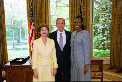 President George W. Bush and Laura Bush congratulate 2003 Maine Teacher of the Year Alicia H. Lewis in the Oval Office Wednesday, April 30, 2003. White House Photo by Eric Draper
