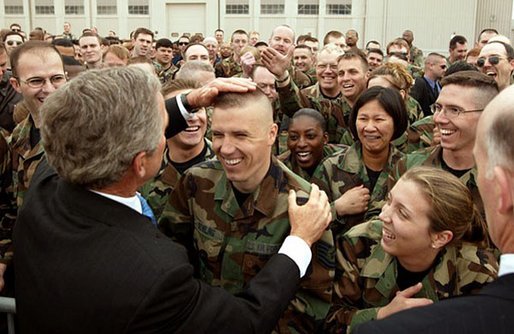 President George W. Bush provides a little touch-up on a soldier’s haircut as he greets military personnel at Wright-Patterson Air Force Base in Dayton, Ohio, April 24, 2003. White House photo by Paul Morse