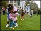 A helping hand is given during the Easter egg roll where little competitors use a spoon to carry a hard-boiled egg through the South Lawn race course and across the finish line at the White House Easter Egg Roll Monday, April 21, 2003. White House photo by Susan Sterner